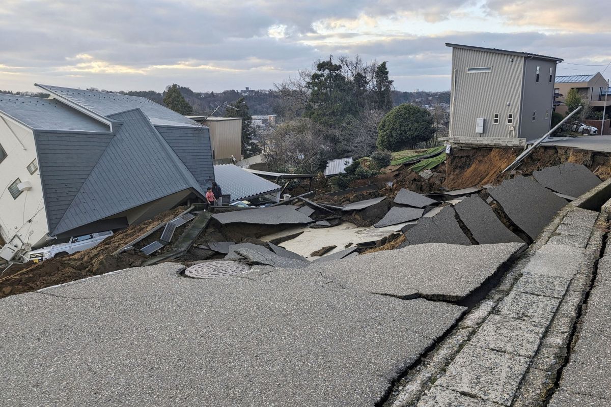 A view of a collapsed road and houses because of an earthquake in Wajima