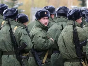 as russian soldiers march forward one looks back