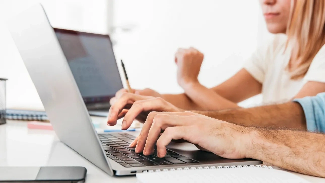 008bf7b2 crop hands typing laptop workplace