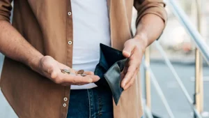 9c8da331 close up hands holding wallet coins